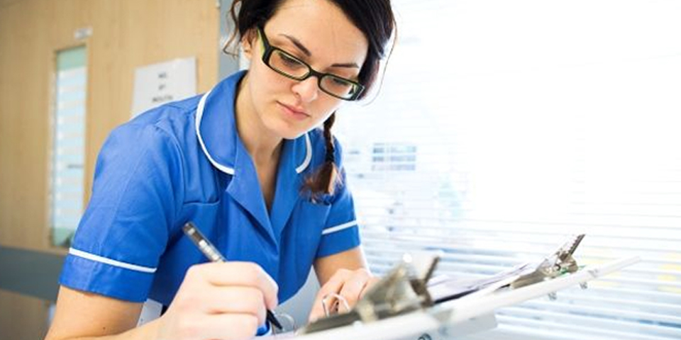 Nurse completing a forms for a patient
